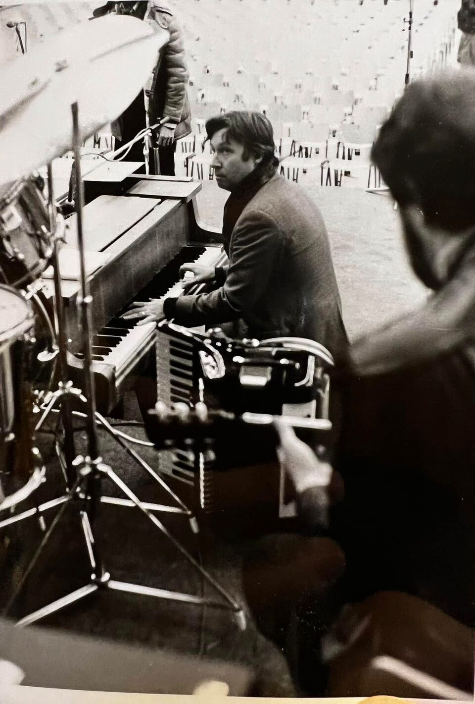 Schwarzweißfoto aus den 1970er Jahren: Peter Alexander spielt auf der Bühne vor leeren Stuhlreihen Klavier, rechts im Vordergrund unscharf Harry Pepl mit der Gitarre. Nach Angaben der Familie jammten die Musiker vor einem Auftritt.