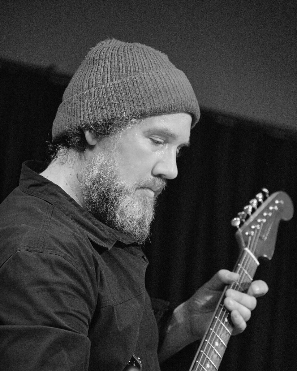 Martin Siewert with guitar and cap at a Radian concert at Club W71, 2025.
